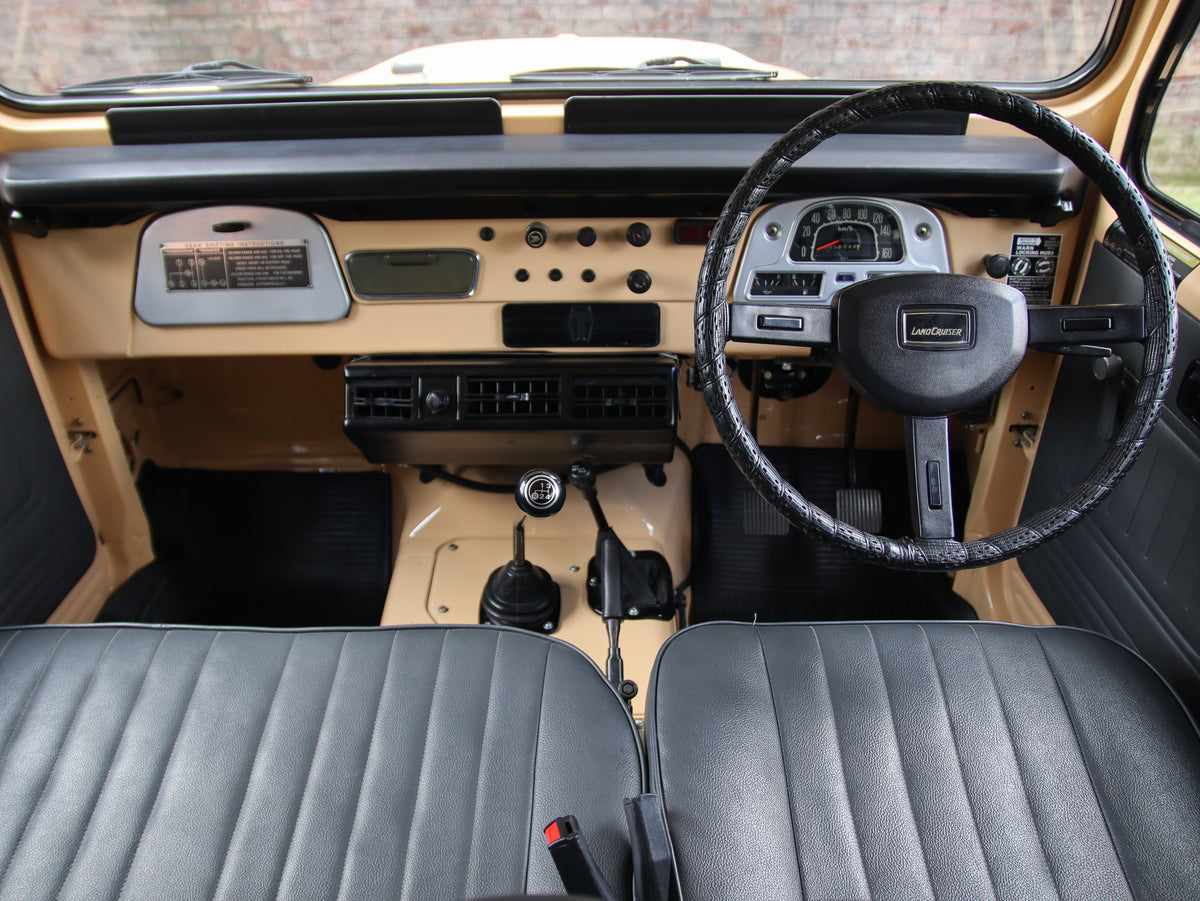 Beige 1981 Toyota FJ40 Land Cruiser with Bulk New Genuine Toyota Parts Toyota Repro Floor Mats and Custom Black Seats