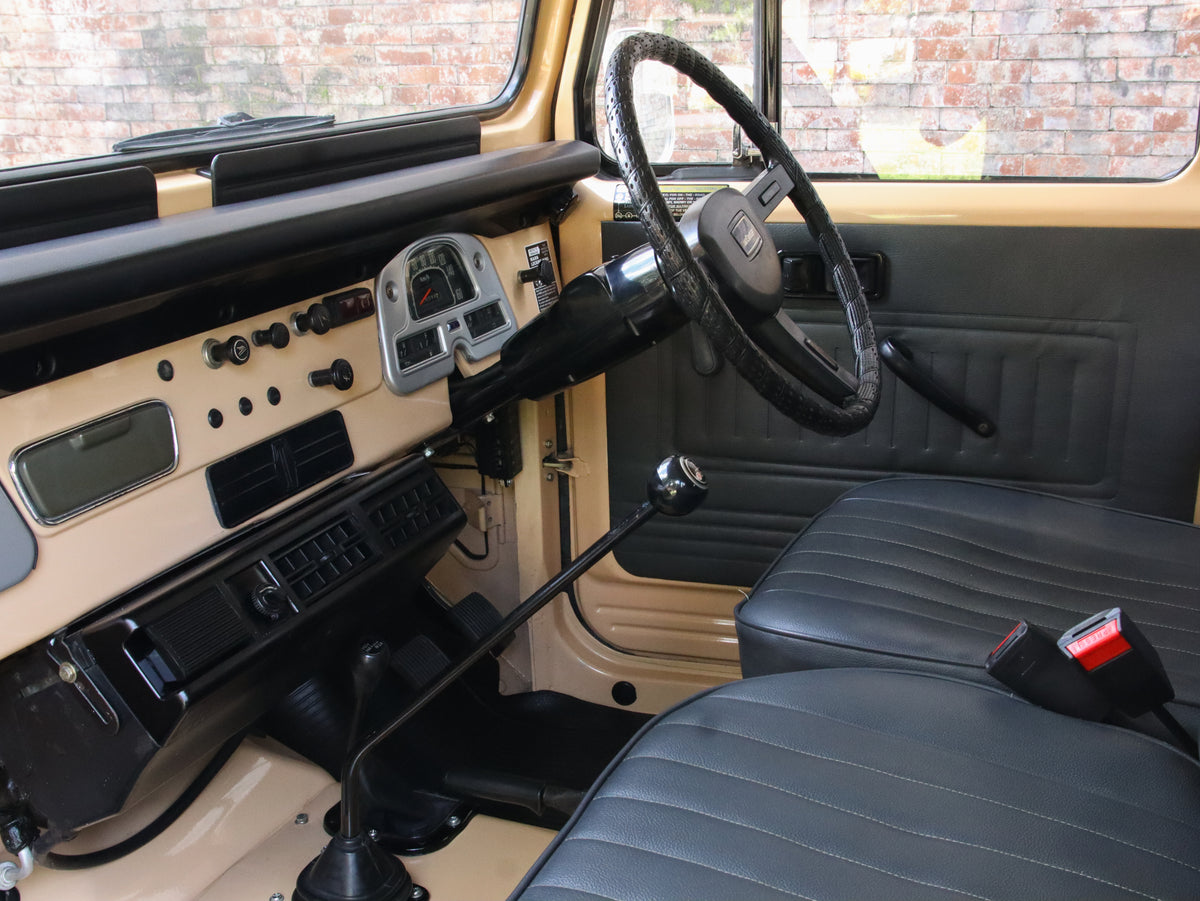 Beige 1981 Toyota FJ40 Land Cruiser with Bulk New Genuine Toyota Parts Toyota Repro Floor Mats and Custom Black Seats